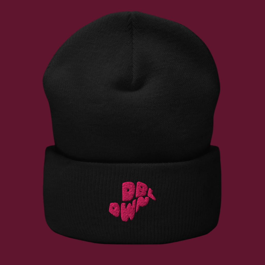 Black beanie with pink text on a purple background